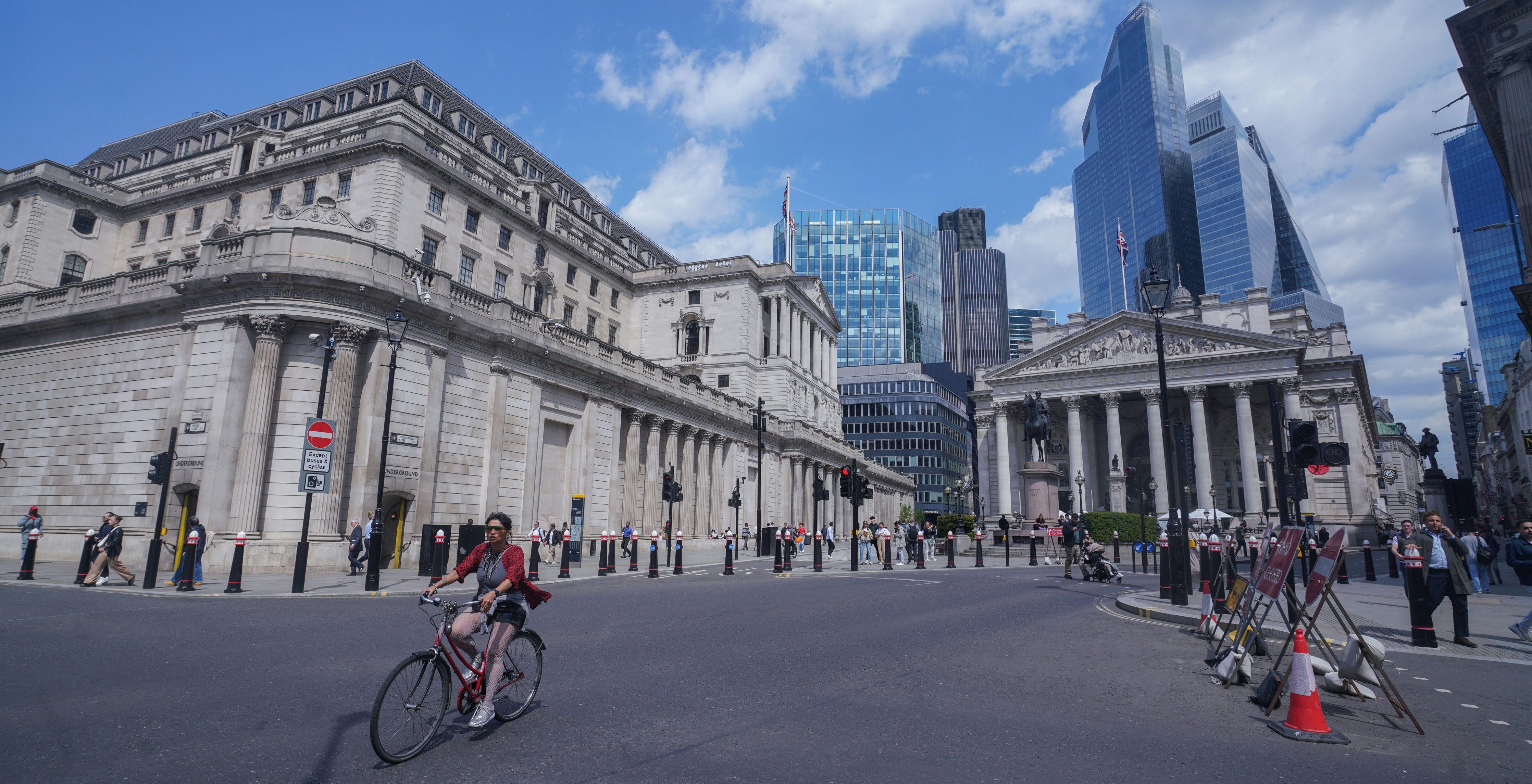 A cyclist rides past the Bank of England in London.